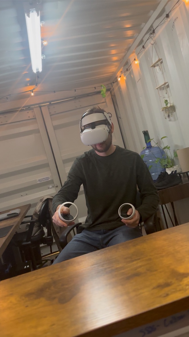 Jacob from Snazzy Solutions using Meta Quest VR headset at his workspace